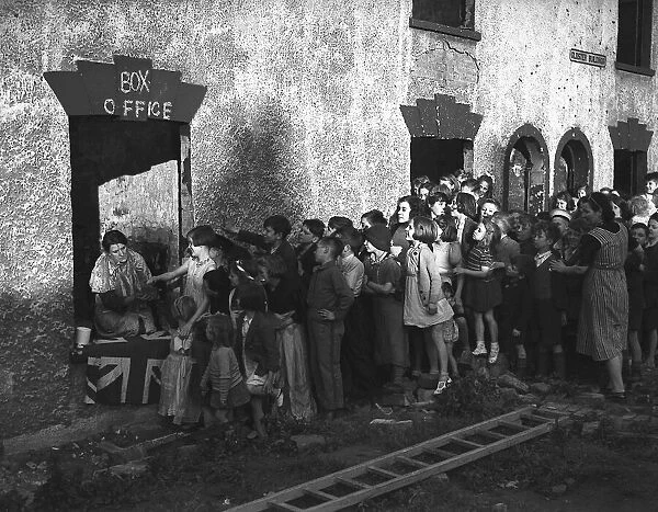 Children queue for show during London blitz The misery of the Blitz is partly alleviated