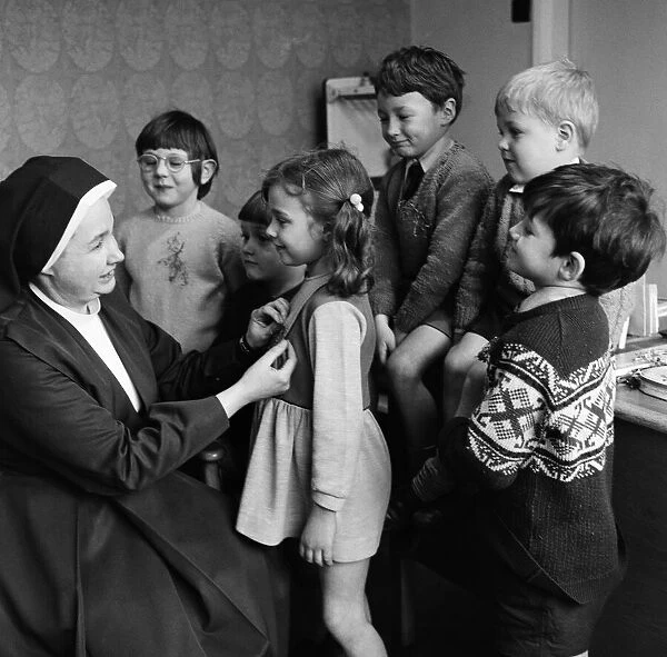 Children at Sacred Heart School, having a shamrock pined to them. 17th March 1971