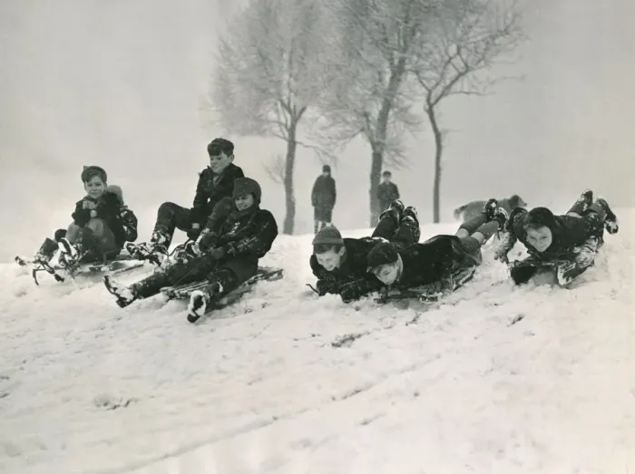 Framed Print : Children sledging down a hill in snow smiling and laughing after a havy snowfall Framed Print : Children sledging down a hill in snow smiling and laughing after a havy snowfall