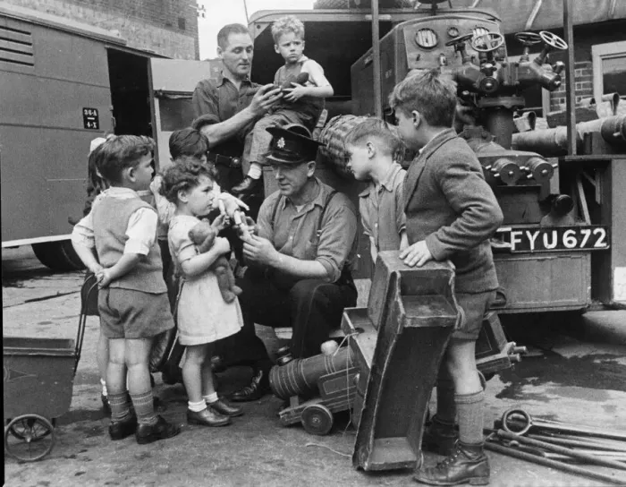 Framed Print : Children from Stoke Newington bring their broken toys to Leading Fireman Herbert Rogers Framed Print : Children from Stoke Newington bring their broken toys to Leading Fireman Herbert Rogers