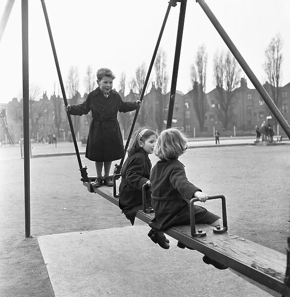 Children on the swings at Paddington recreation grounds. 30th March 1954