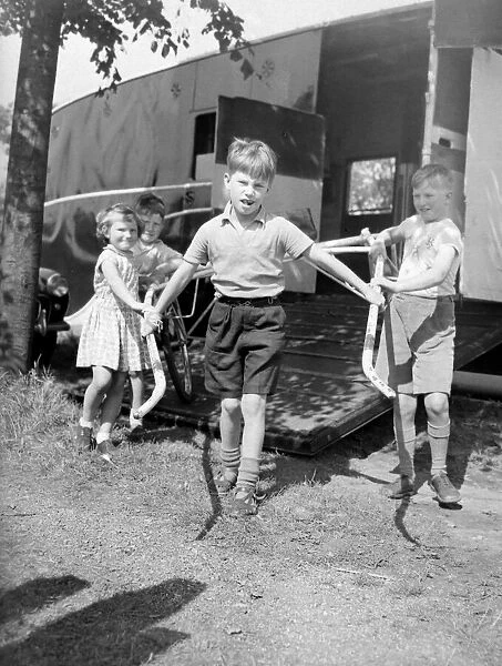 Children unloading a racing sulky, the light frame the jockey rides in during a trotting