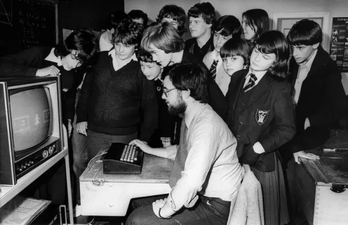 Framed Print : Children using computers. The mother of one of the pupils at Benfield Road School