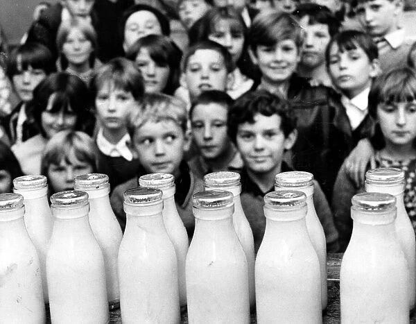 Children waiting for their daily bottle of milk. Circa 1970
