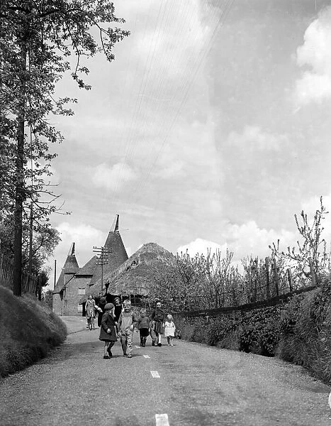 Children walking down a country lane in a typical Kent village
