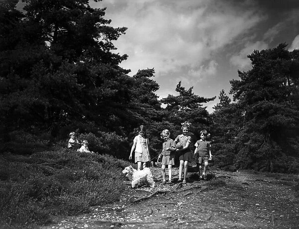 Children walking through the countryside. Circa 1940