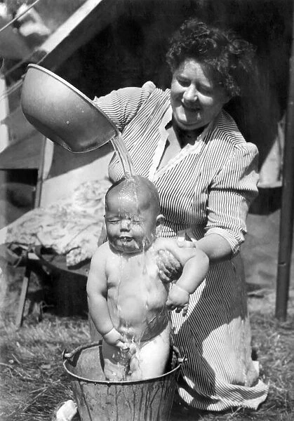 Children: Washing: Mrs. Ann Farrier gives her son 8 months old John his morning bath in a