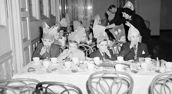 Children at the yearly Daily Mirror Christmas Childrens Party tuck into their food
