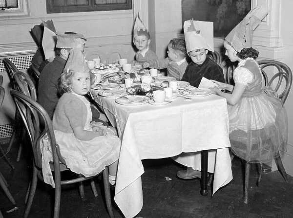 Children at the yearly Daily Mirror Christmas Childrens Party tuck into their tea