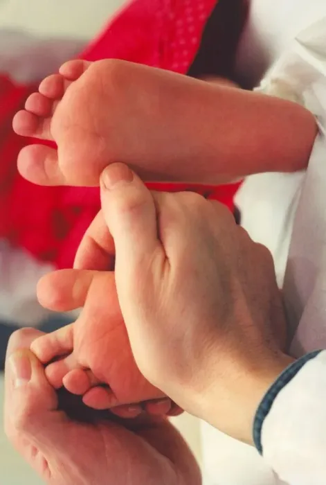 Framed Print : A childs feet being inspected Framed Print : A childs feet being inspected