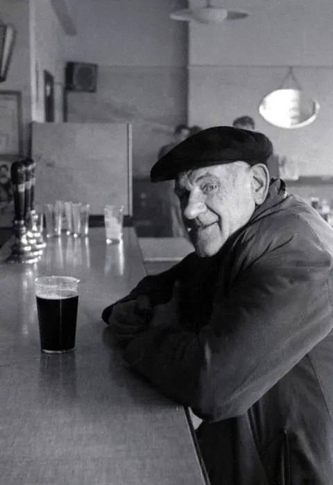 Framed Print : The Chimes Lansbury Public House Pub - 1953 A old man sits at the bar with a pint