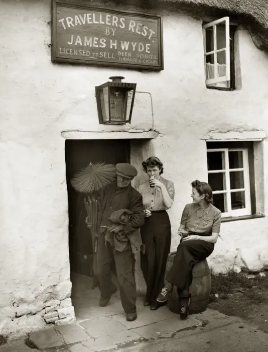 Framed Print : A chimney sweep passes two land girls enjoying a well earnt break from their toil in Framed Print : A chimney sweep passes two land girls enjoying a well earnt break from their toil in