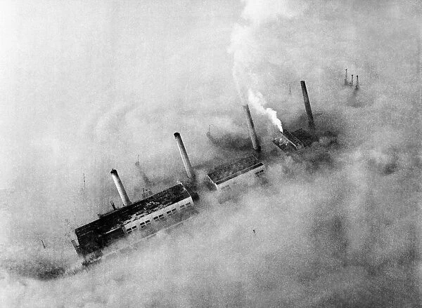 Chimneys of an East End factory poke through the blanket of smog covering London
