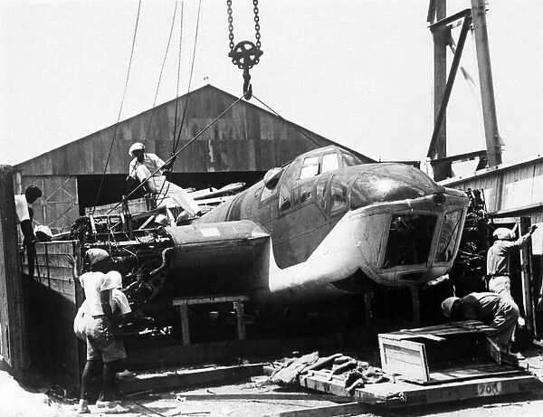 Chinese labourers prising open the case on the arrival of the Bristol Blenheim Mark IV
