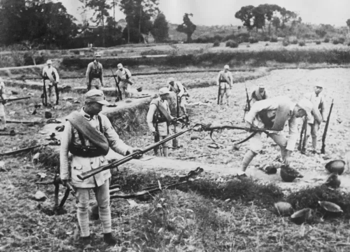 Framed Print : Chinese soldiers pick up the discarded weapons of Japanese soldiers who have fled Framed Print : Chinese soldiers pick up the discarded weapons of Japanese soldiers who have fled