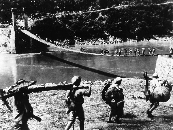 Chinese troops carry supplies along the Salween River in Southern China during WW2