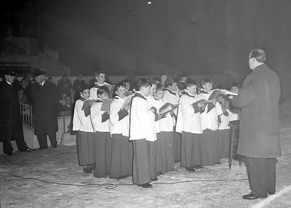 The choir of Holy Trinity Church, Coventry, singing carols at Highfield Road football