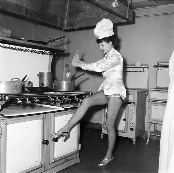 Chorus Girl rehearsing in the kitchen whilst preparing dinner. D748-001