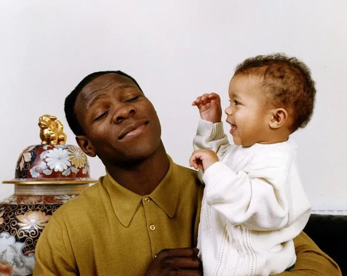 Framed Print : Chris Eubank boxer holding his baby in his arms Framed Print : Chris Eubank boxer holding his baby in his arms