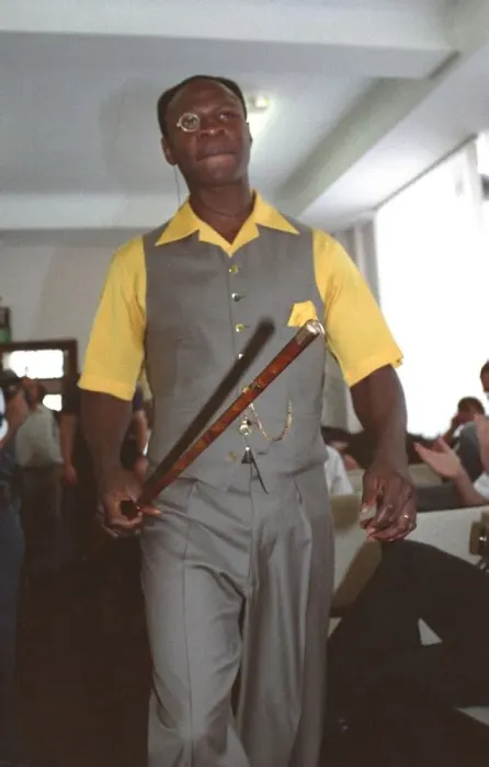 Framed Print : Chris Eubank Boxing in grey waist coat and trousers and yellow short sleeve shirt struts Framed Print : Chris Eubank Boxing in grey waist coat and trousers and yellow short sleeve shirt struts