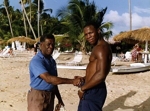 Chris Eubank Boxing shaking hands with man on beach