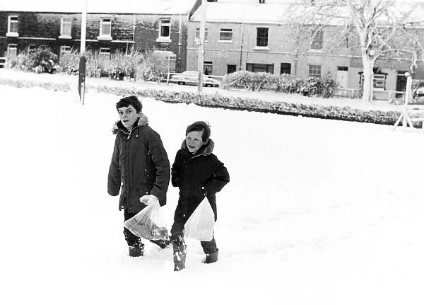 Christian Clapton (left) and Paul Isbel (right) trudge through the thick snow to get to