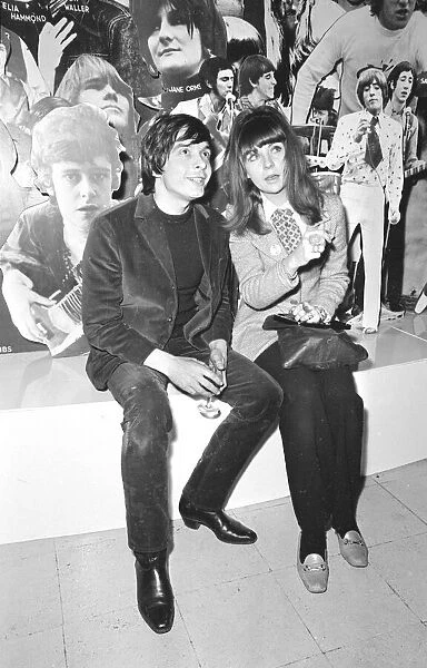 Christine Shrimpton with David Bailey. sitting in front of Photographic montage