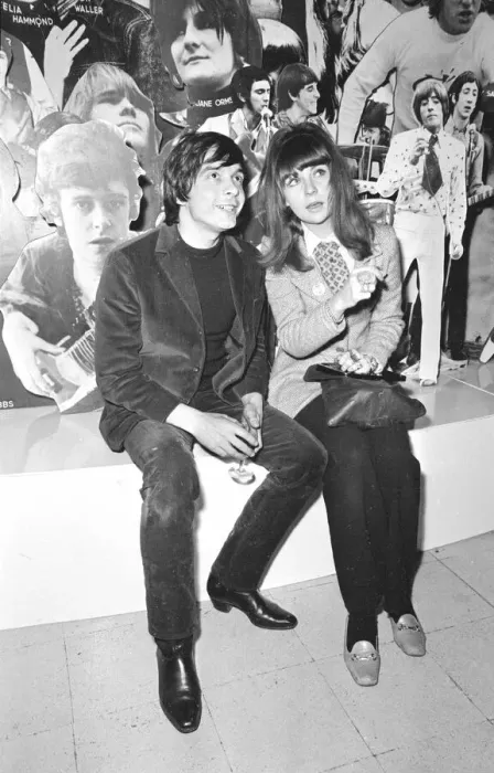 Framed Print : Christine Shrimpton with David Bailey. sitting in front of Photographic montage Framed Print : Christine Shrimpton with David Bailey. sitting in front of Photographic montage
