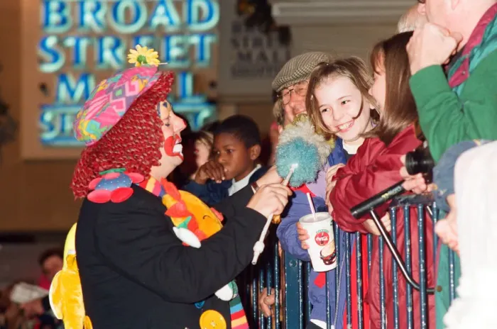 Framed Print : Christmas light switch on at Broad Street Mall, Reading. A clown entertains the crowds