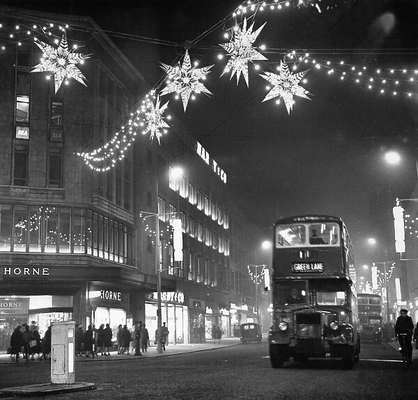Christmas lights of shimmering stars hang over Lord Street near the corner of Whitechapel