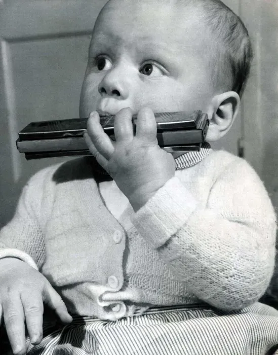 Framed Print : Christopher Thomas tries to play his fathers mouth organ Framed Print : Christopher Thomas tries to play his fathers mouth organ