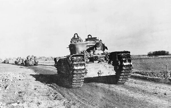 Churchill tanks roll into battle. Churchill tanks of the Royal Armoured Corps move