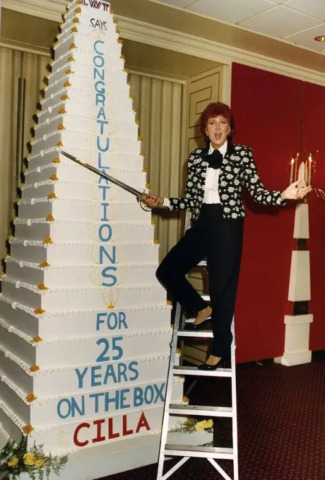 Framed Print : Cilla Black on a step ladder about to cut her cake with a sword celebrating her 25 Framed Print : Cilla Black on a step ladder about to cut her cake with a sword celebrating her 25