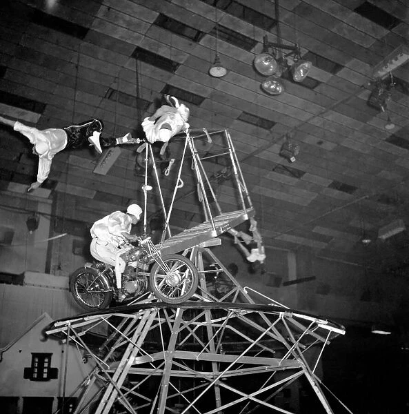 A circus novelty act based on the motorcycle wall of death combined with acrobats