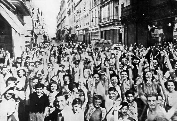 Civilian residents of Cannes cheer the entry of Allied Forces of Liberation as they