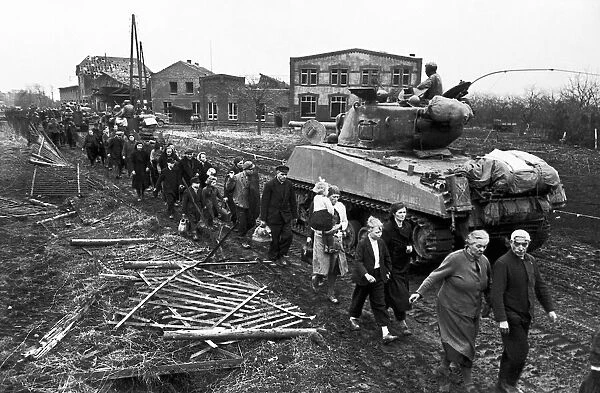 Civilians leave Erkelenz, Germany after its capture by the Allies. March 1945