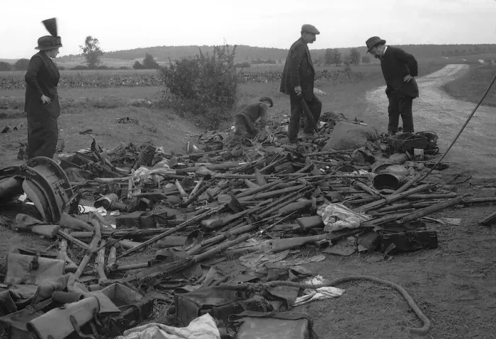 Framed Print : Civilians look at heap of rifles left in the field by the Germans during World War Framed Print : Civilians look at heap of rifles left in the field by the Germans during World War