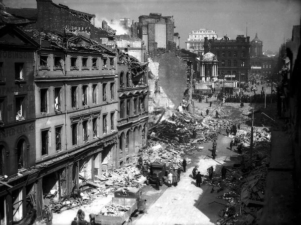 Civilians and rescue workers search through the the bomb damage buildings in the centre