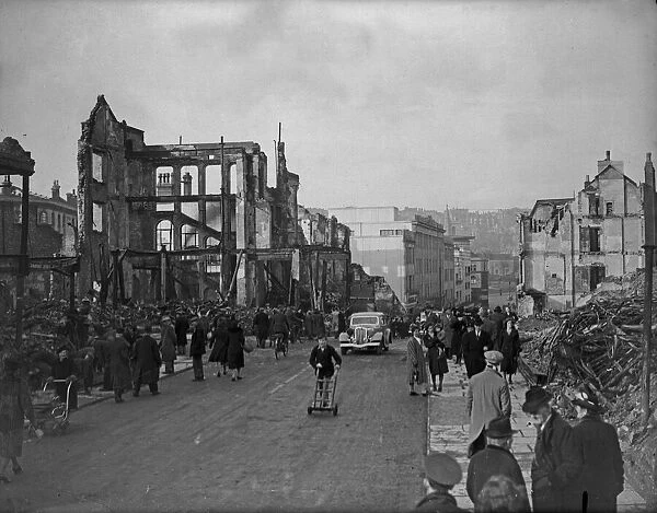 Civilians walk amongst the ruins of Dolphin Street following a further raid on Bristol by