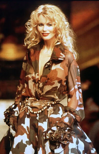 Claudia Schiffer, supermodel, at Paris Fashion show wearing Valentino camouflage outfit
