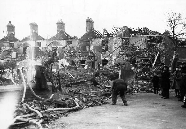 Clearing away the debris from damaged properties in a South Wales town. Circa 1941