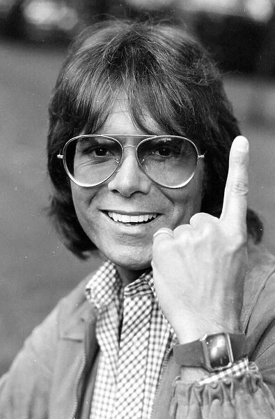 Cliff Richard celebrates after hearing that his current single 'We don