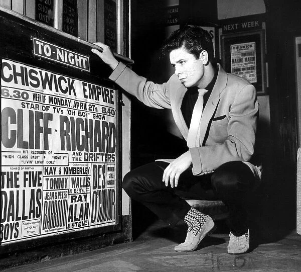 CLIFF RICHARD LOOKING AT CONCERT POSTER WITH HIS NAME AS TOP-BILLING - 1958