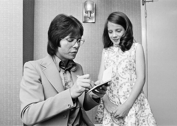 Cliff Richard signing autograph for a young fan, he is starring in Take Me High