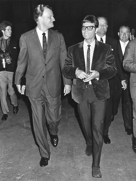 Cliff Richard walking with Billy Graham during his visit to England - June 1966