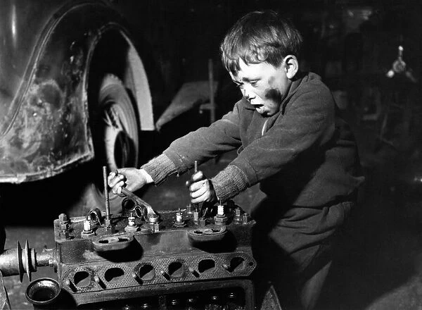 Clockwork? Huh, Kids Stuff! 6 year old David Redford working on a car in his foster