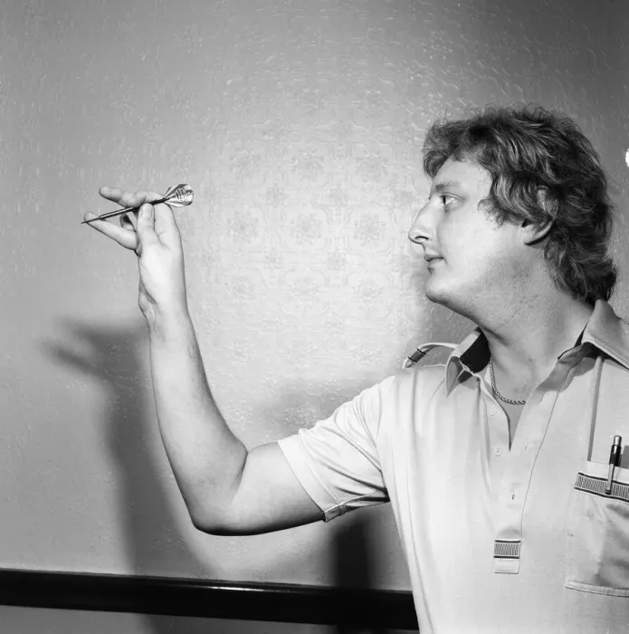 Framed Print : Close up feature on British darts player Eric Bristow in dart throwing action Framed Print : Close up feature on British darts player Eric Bristow in dart throwing action