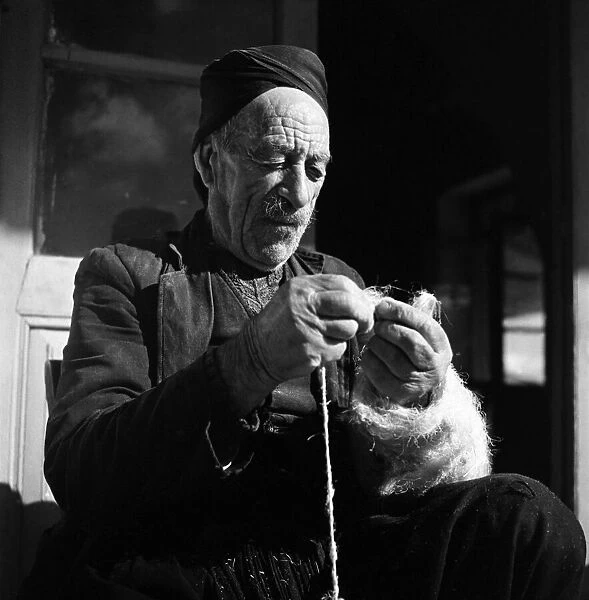 Closeup of man making string in Cyprus town. November 1952 C1103-001