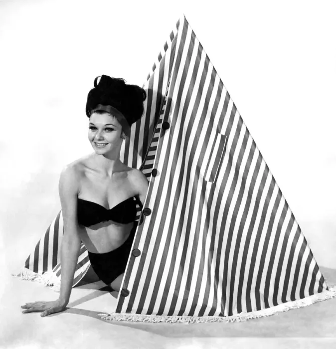 Framed Print : Clothing Beach 1963. Model Merril Weston shows how to use the striped cape-tent Framed Print : Clothing Beach 1963. Model Merril Weston shows how to use the striped cape-tent