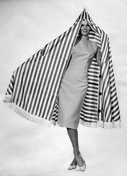 Clothing Beach 1963. Model Merril Weston wears a calf-length dress and shoes
